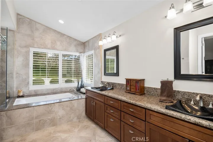 Custom tile, tub, vanity, mirrors, lighting and shower. All replaced to the walls!