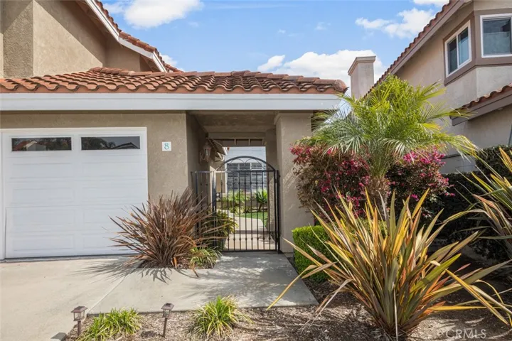 Low maintenance front landscape and garage doors with windows.