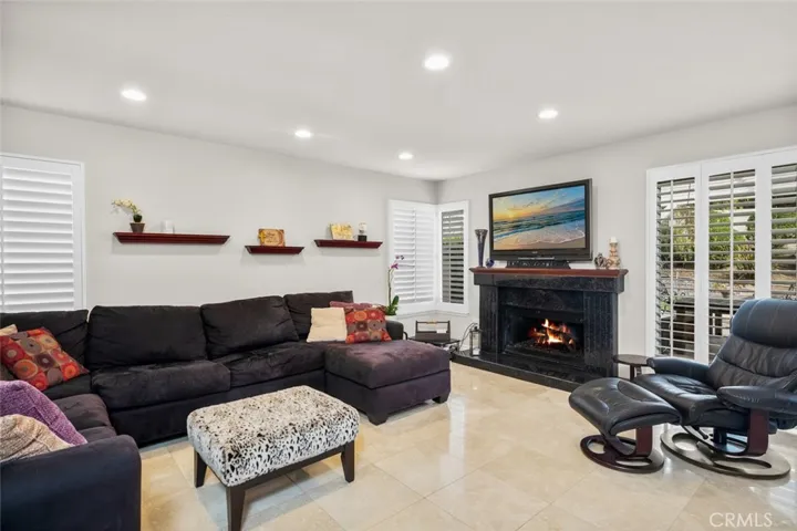 Inviting family room with cozy fireplace and Plantation Shutters on every window in the house for the most part.