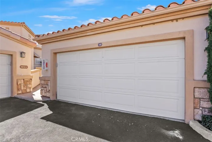 Garage door. Access the home directly by going up to the ramp to the left of this garage.