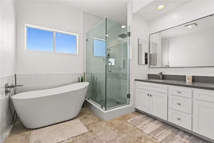 Remodeled Primary Ensuite with Dual Vanity and Separate Soaking Tub.