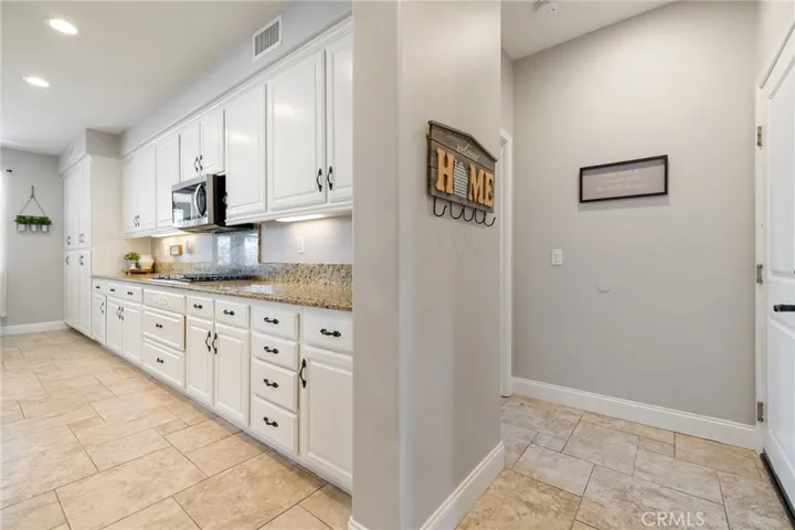 Right: access to the 3-car garage and main floor bedroom with attached bath