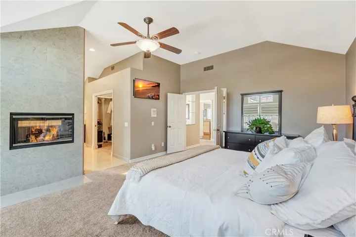 Primary en-suite bedroom and bathroom retreat with heated floors, complete with a large walk-in shower and separate jacuzzi tub, along with dual vanity sinks and a custom walk-in closet