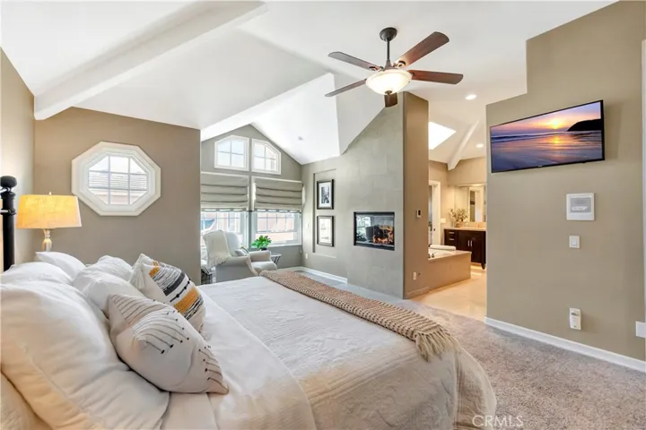 Primary en-suite bedroom with a double-sided fireplace