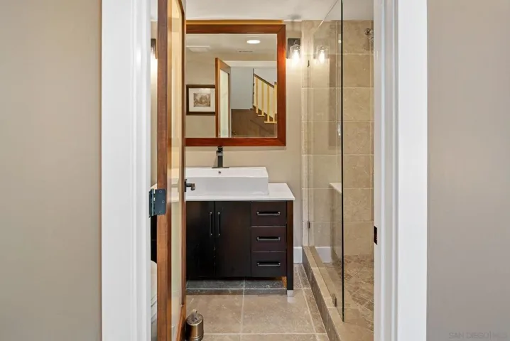 Full bath serves the living area and the downstairs bedroom/rec-room.