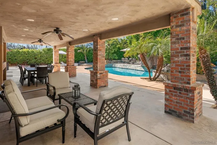 Enjoy outdoor living under this large covered patio with 2 built-in ceiling fans, a series of can lights, a connection for a big-screen TV, and a gas stub for a BBQ.