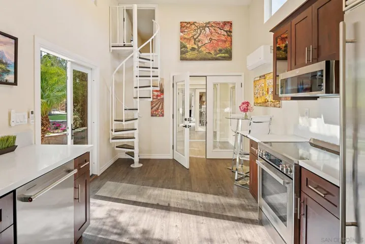 The circular staircase leads to a loft with a low (3-4ft) ceiling.  The double doors to the right of the staircase leads to the bedroom.  Both bedroom and living area each have a mini-split air conditioning system.