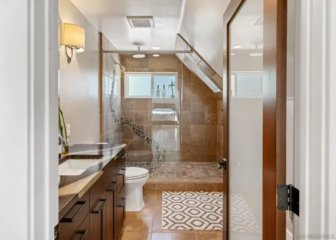 The massive stone shower has a skylight on the right to open if you like an open-air experience.