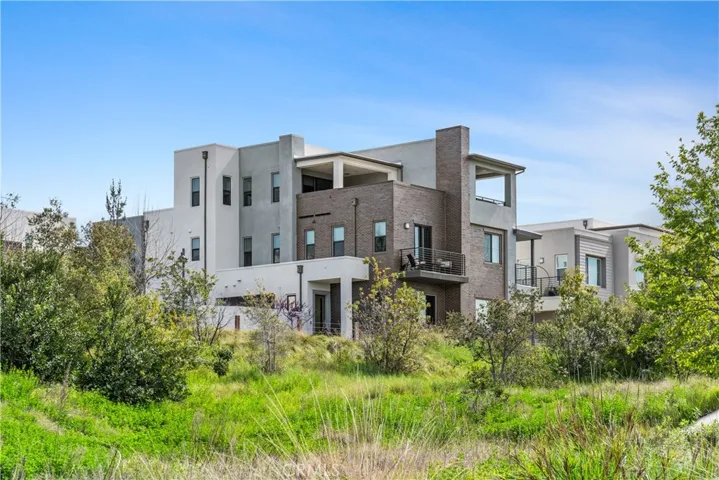 modern architectural design, well-maintained landscaped grounds, corner location, and ample parking for residents and visitors
