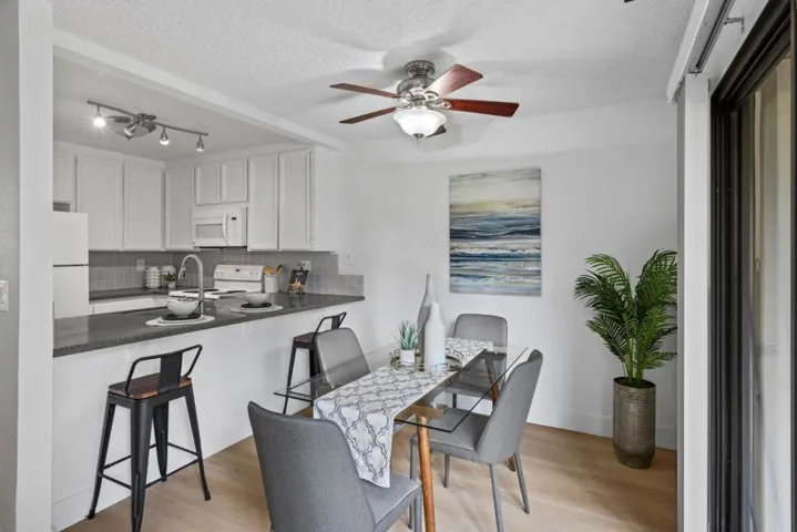 Dining area with slider to private patio and pass through access to kitchen