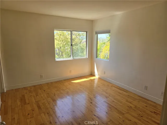 SECONDARY BEDROOM W/ WOOD FLOORING