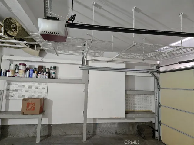 LOTS OF OVERHEAD STORAGE PLUS SHELVING IN GARAGE