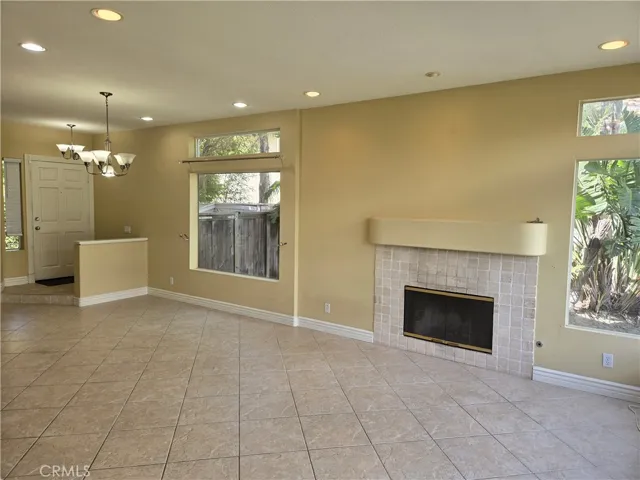 SPACIOUS LIVING/DINING COMBO W/ TILE FLOORING, TONS OF NATURAL LIGHT, COZY FIREPLACE AND RECESSED LIGHTING