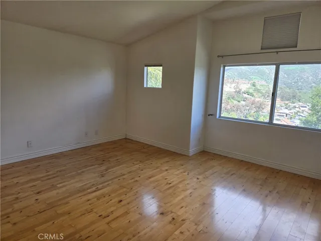 PRIMARY BEDROOM W/ WOOD FLOORING AND GREAT VIEWS TO ENJOY