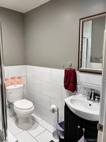 Master bathroom toilet area and shower with tub