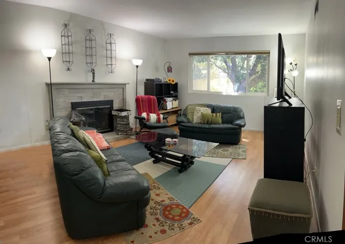 As you step through the main door of the house, turning left brings you to a private and secluded sunken formal living room, complete with a cozy fireplace