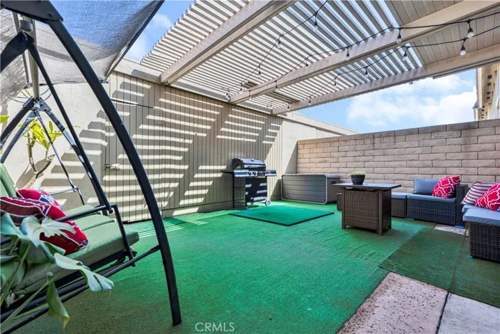 large private covered patio with block-wall fencing, ideal for outdoor living and relaxation
