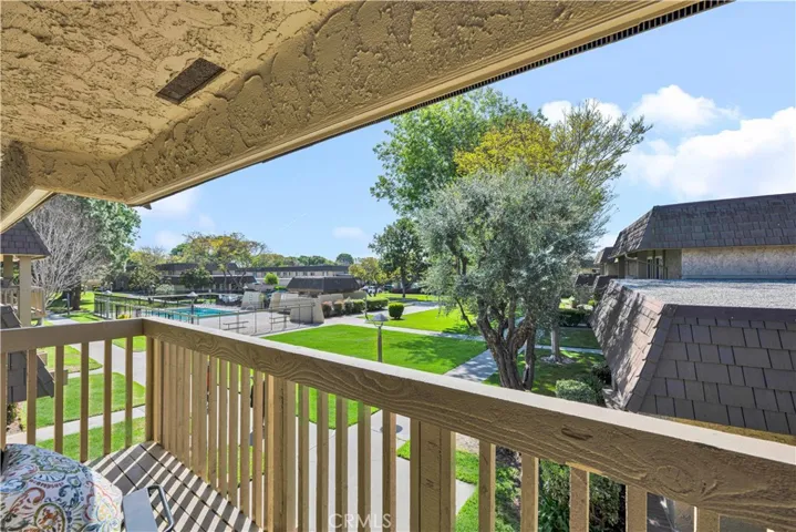 sliding glass doors opening to a private balcony overlooking the lush greenbelt