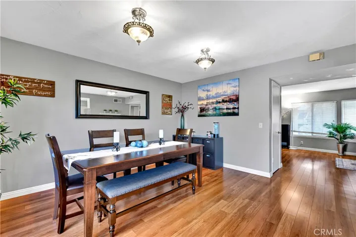 rich hardwood flooring in the living and dining areas