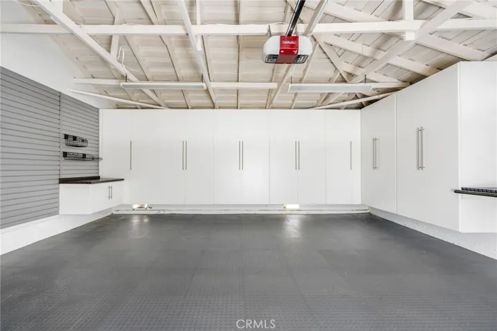 Finished garage with large storage cabinets.