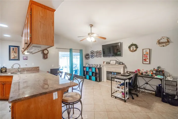 Family room with fireplace, slider door to side yard patio that wraps around to the back.