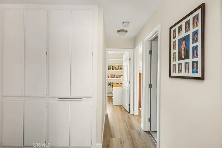 hallway from primary to 2 bedrooms and full bath