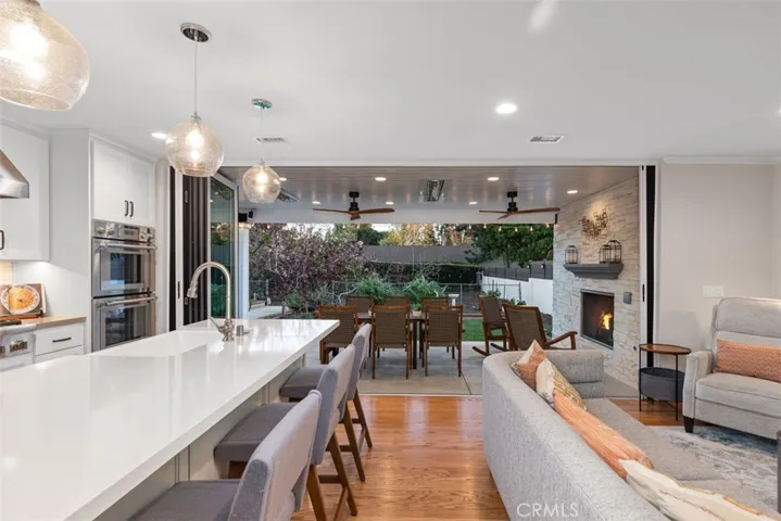 Gourmet kitchen with panoramic doors that lead out to the luxury patio and garden