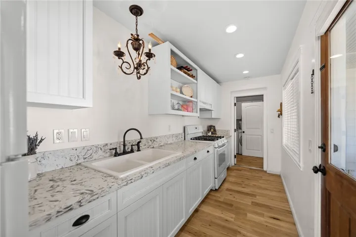 Both Kitchens Showcase Custom-Built Cabinetry, Quartz Countertops, Farmhouse Sinks, And High-End Finishes