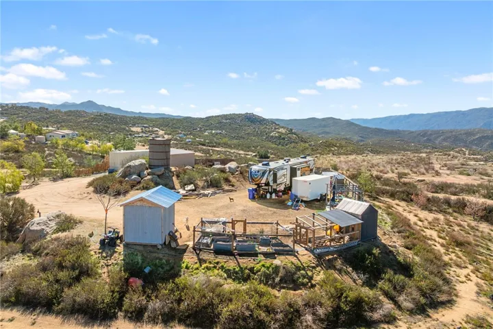 A 50' Cargo Container With An Attached Shed Cover, RV Hookups, And Perimeter Cattle Fencing