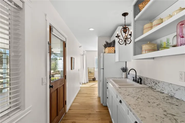 Both Kitchens Showcase Custom-Built Cabinetry, Quartz Countertops, Farmhouse Sinks, And High-End Finishes