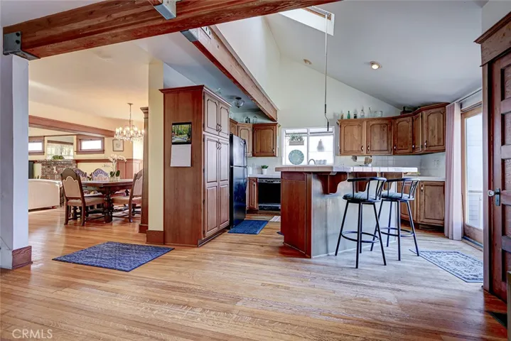 The kitchen was expanded, opened up and remodeled in the late 80's, and features ceiling beams, a large skylight kitchen island, garden window, wood slidiers to the back yard, and an adjacent family room/office area.
