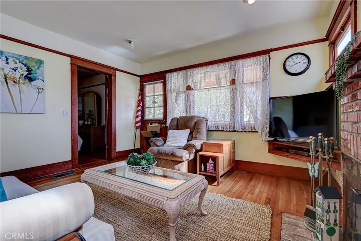 Wood picture rail at the top, extra wide original floor moldings and original oak hardwood floors!
