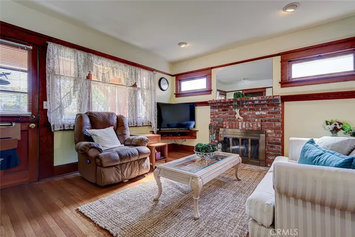 Brick fireplace has been rebuilt with used bricks and is flanked by original hopper (bottom hinged) windows.