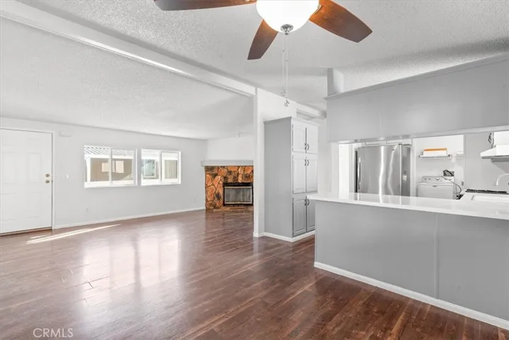 Kitchen and living area Fireplace new ceiling fans