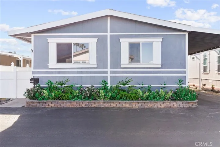 Front of home with full flower planter. staged