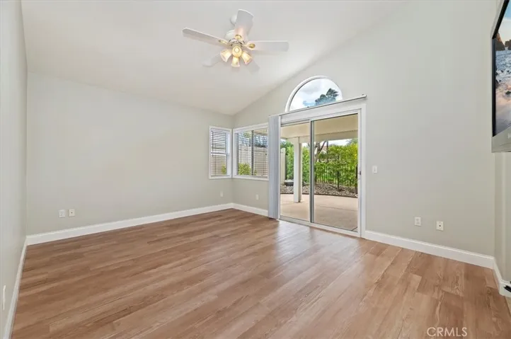 Spacious primary bedroom with high ceiling