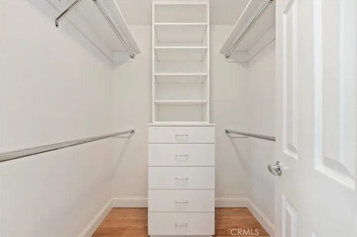 Primary walk-in closet with custom built-ins