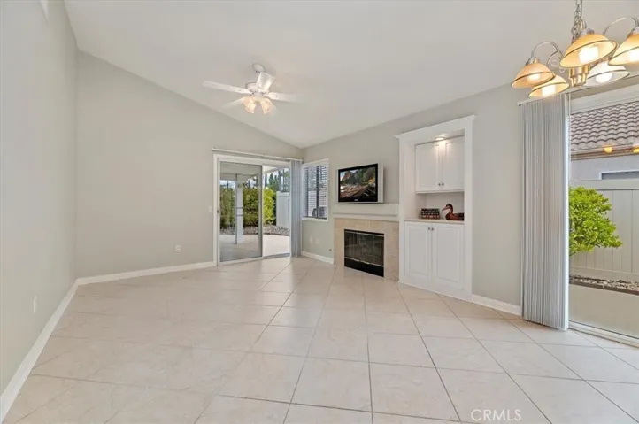 Family room with a fireplace and built-in cabinet