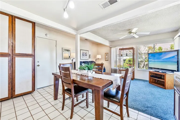Door leading to garage, tiled flooring and the family room view..