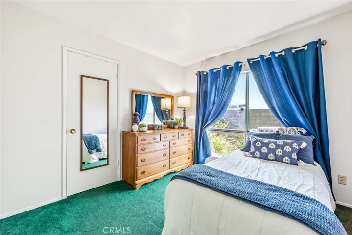 Second bedroom with a large window and closet.