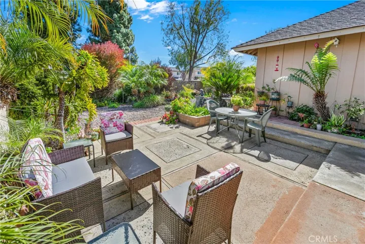 Patio area off the family room with the lush gardens