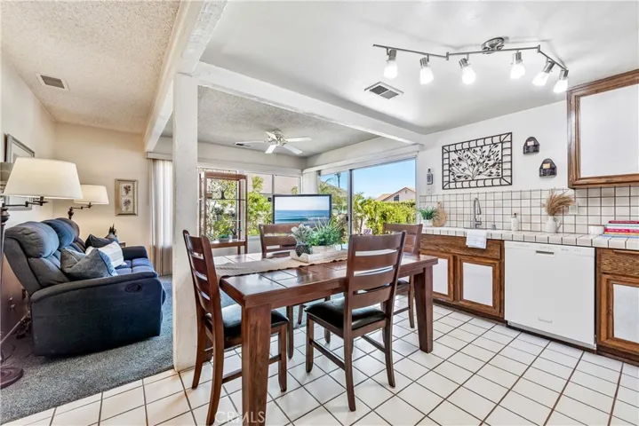 Large open floor plan kitchen and family room looking out to the lush gardens backyard.