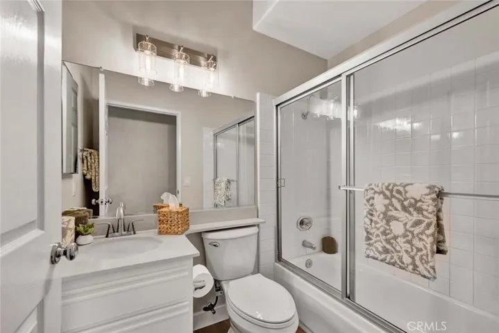 Guest bathroom with new toilet and fixtures, bathtub shower combo