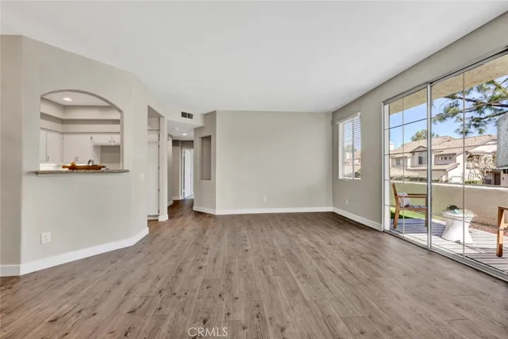 Open concept living with sliding glass door access to private patio