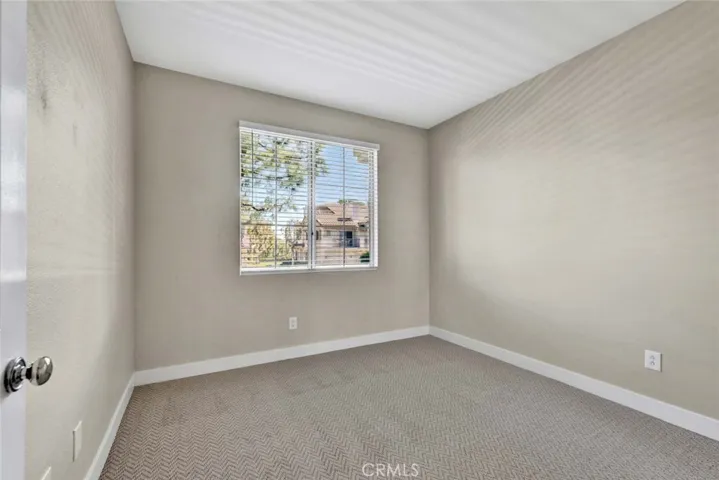 Sizable guest bedroom with window to patio