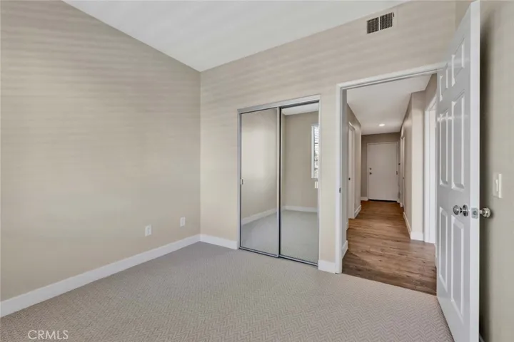 Mirrored closet doors in guest bedroom
