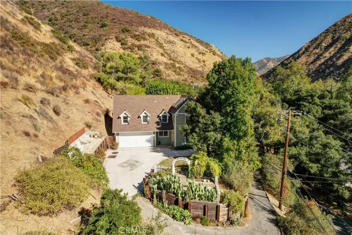 Showing entrance to the property at the lower  end of the driveway