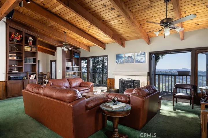 Beamed ceilings, cozy fireplace, built in bookcases and forever views.