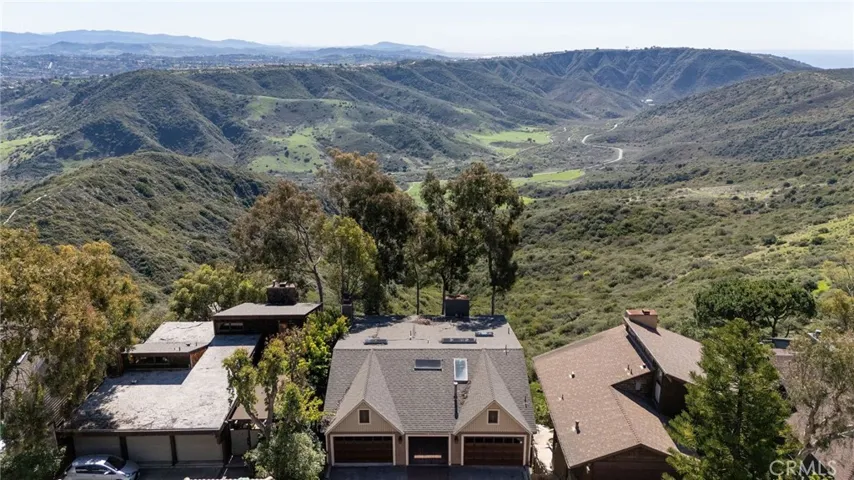 Perched atop Old Top of the World, this spacious 3900 sq ft residence captures panoramic vistas of the ocean, rolling hills, Aliso Creek canyon, and city lights.