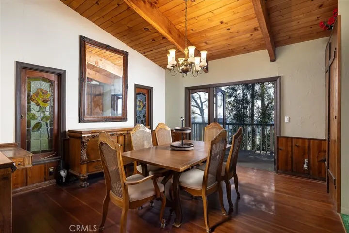 The ideal dining room space extends off the kitchen and is surrounded by stain-glassed windows and tree and canyon views.